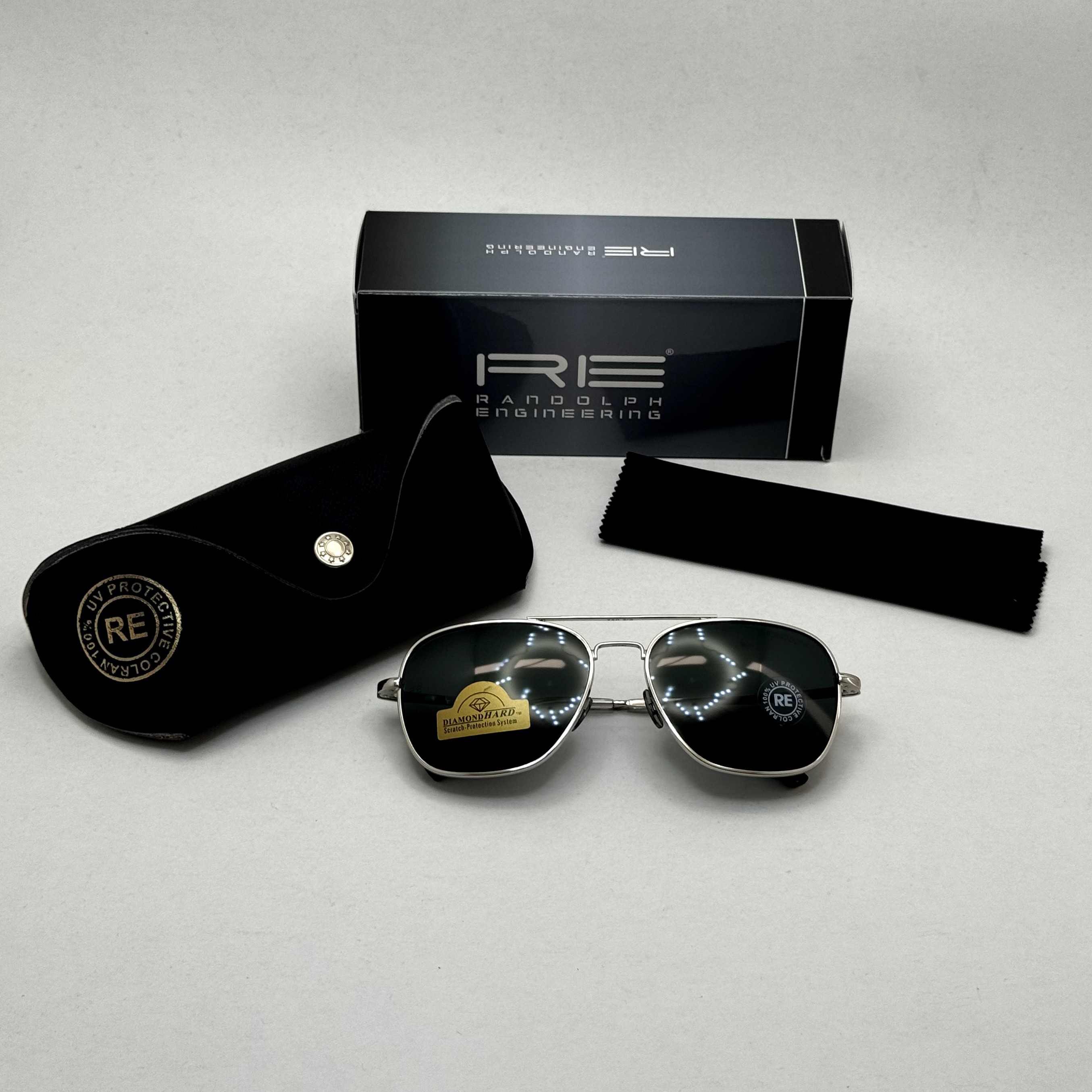 عینک آفتابی خلبانی رندولف شیشه سنگ آنتی رفلکس مشکی فریم نقره ای فول پک RANDOLPH AVIATOR  RE 58 WHITE GOLD